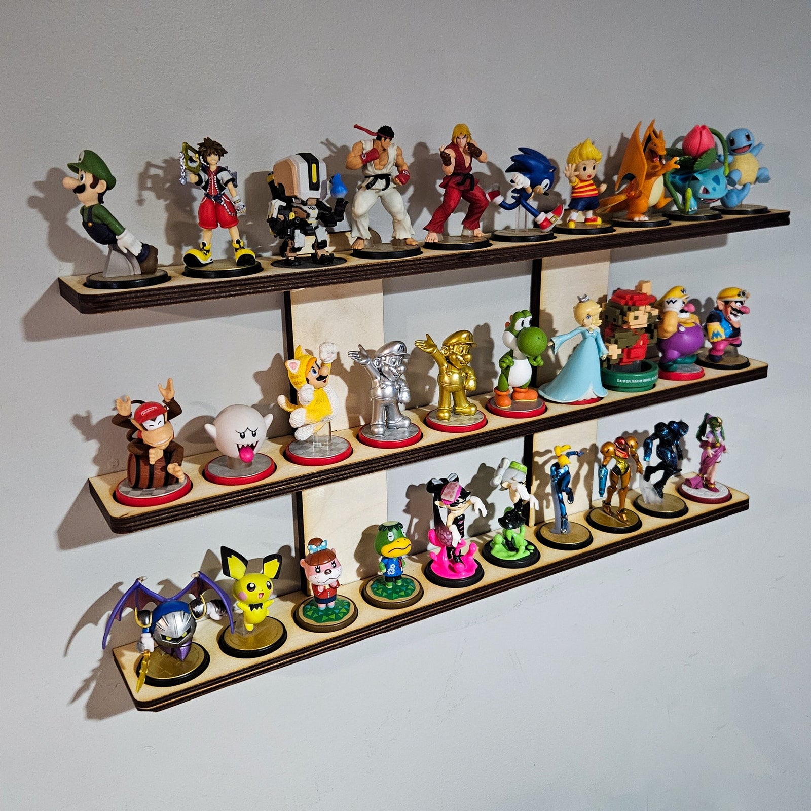 A multi-tiered wall shelf with various colorful amiibo figures arranged on it.